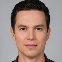 Joyful white adult male with short  brown hair and brown eyes