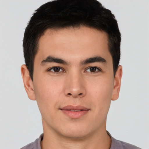 Joyful latino young-adult male with short  brown hair and brown eyes