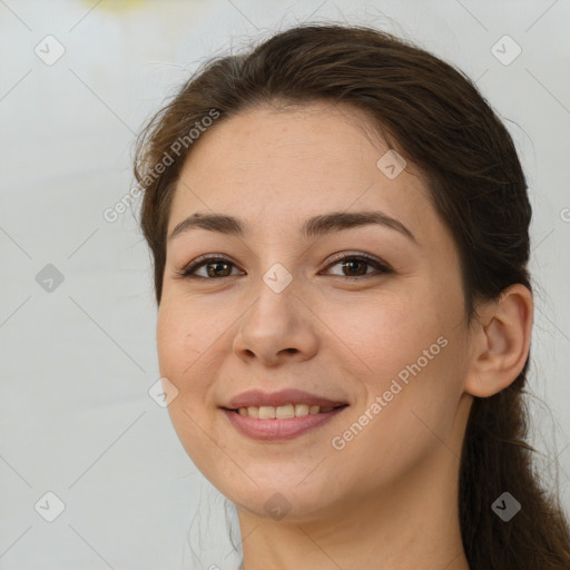 Joyful white young-adult female with long  brown hair and brown eyes