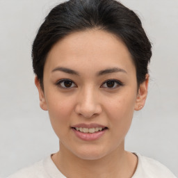 Joyful asian young-adult female with short  brown hair and brown eyes