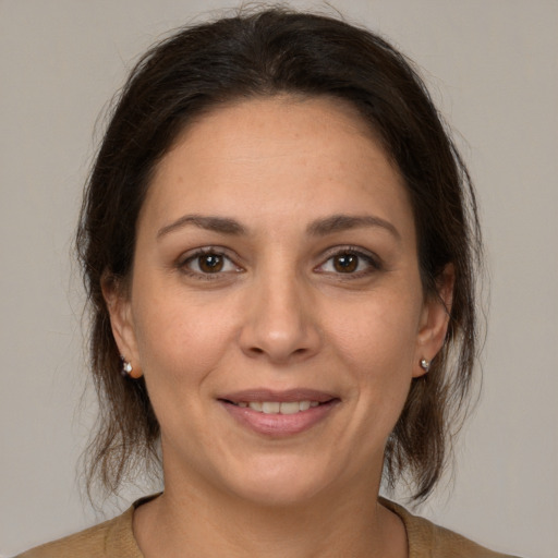 Joyful white adult female with medium  brown hair and brown eyes