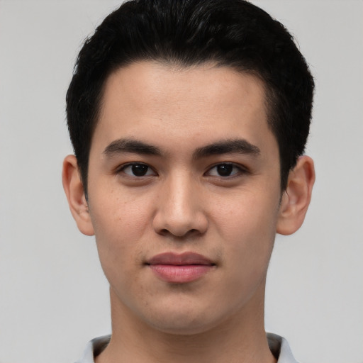Joyful asian young-adult male with short  black hair and brown eyes