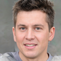 Joyful white adult male with short  brown hair and grey eyes