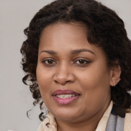 Joyful black adult female with medium  brown hair and brown eyes