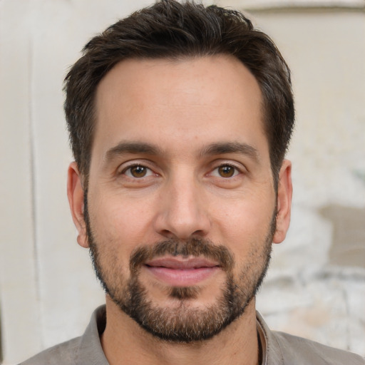 Joyful white young-adult male with short  brown hair and brown eyes