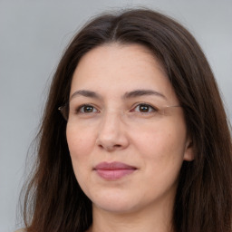 Joyful white adult female with long  brown hair and brown eyes