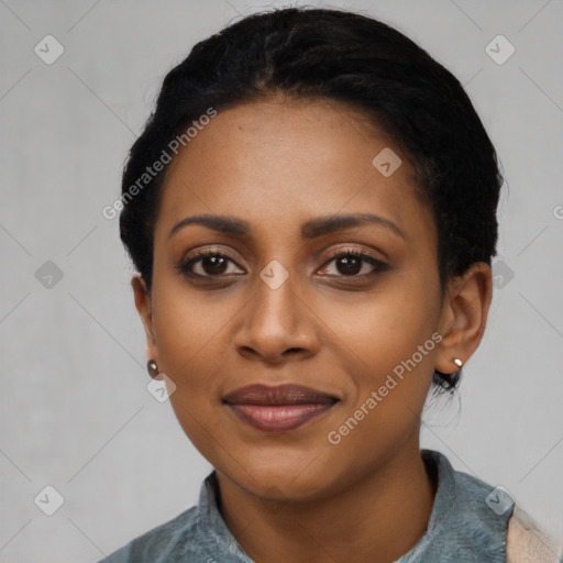 Joyful black young-adult female with short  black hair and brown eyes