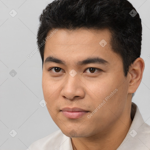 Joyful asian young-adult male with short  black hair and brown eyes