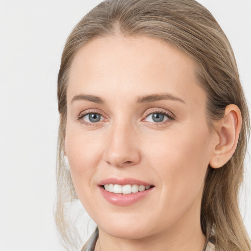 Joyful white young-adult female with long  brown hair and grey eyes