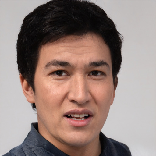 Joyful white adult male with short  black hair and brown eyes