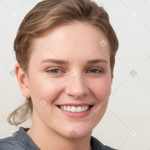 Joyful white young-adult female with medium  brown hair and blue eyes