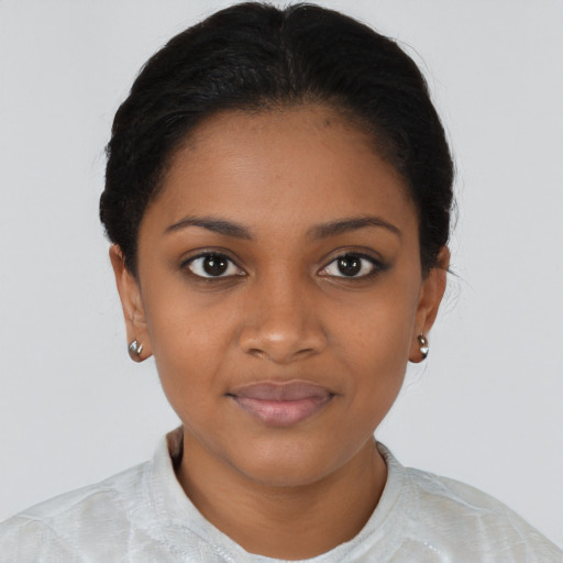 Joyful black young-adult female with short  black hair and brown eyes