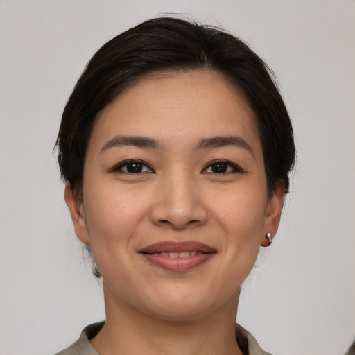 Joyful latino young-adult female with short  brown hair and brown eyes