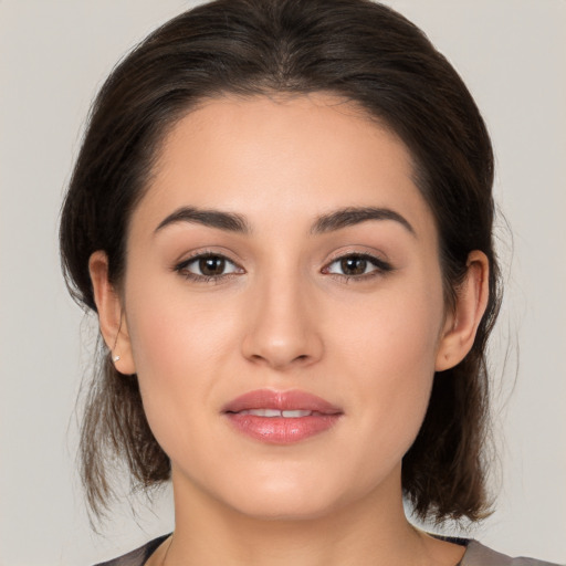 Joyful white young-adult female with medium  brown hair and brown eyes