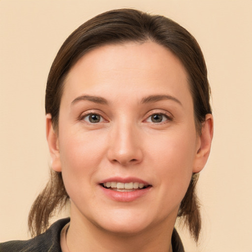 Joyful white young-adult female with medium  brown hair and brown eyes