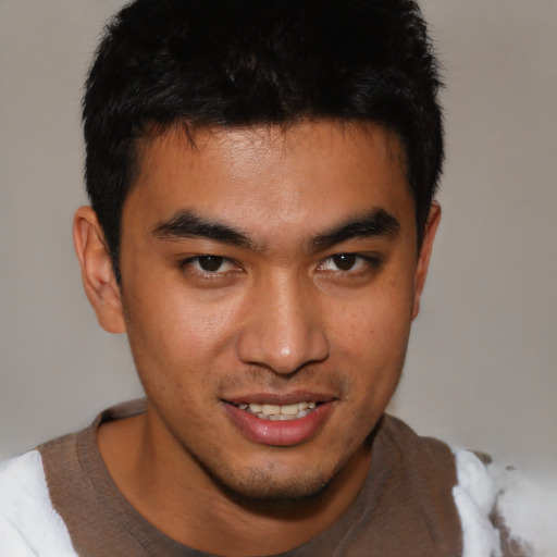 Joyful asian young-adult male with short  brown hair and brown eyes