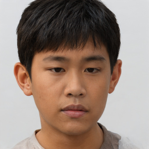 Neutral asian child male with short  brown hair and brown eyes