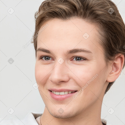 Joyful white young-adult female with short  brown hair and grey eyes