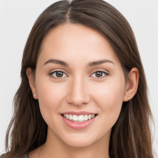 Joyful white young-adult female with long  brown hair and grey eyes