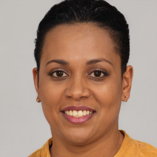 Joyful black young-adult female with short  brown hair and brown eyes