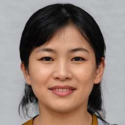 Joyful asian young-adult female with medium  black hair and brown eyes