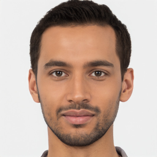 Joyful latino young-adult male with short  brown hair and brown eyes