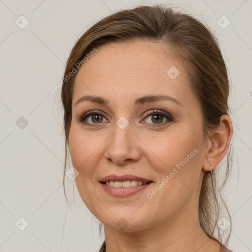 Joyful white young-adult female with long  brown hair and green eyes