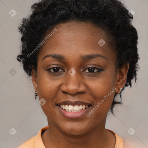 Joyful black young-adult female with short  black hair and brown eyes