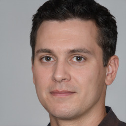 Joyful white adult male with short  brown hair and brown eyes