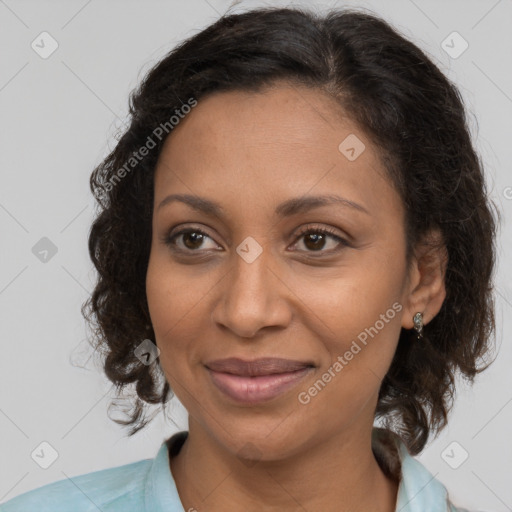 Joyful black adult female with medium  brown hair and brown eyes