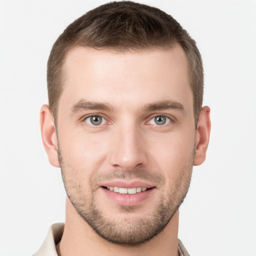 Joyful white young-adult male with short  brown hair and grey eyes