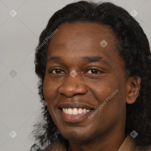 Joyful black adult male with short  black hair and brown eyes