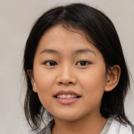 Joyful asian child female with medium  brown hair and brown eyes