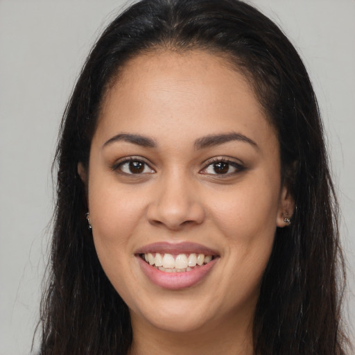 Joyful latino young-adult female with long  brown hair and brown eyes