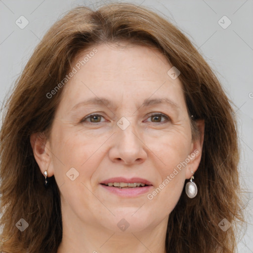 Joyful white adult female with long  brown hair and brown eyes