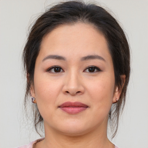 Joyful white young-adult female with medium  brown hair and brown eyes