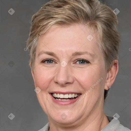 Joyful white adult female with short  brown hair and grey eyes