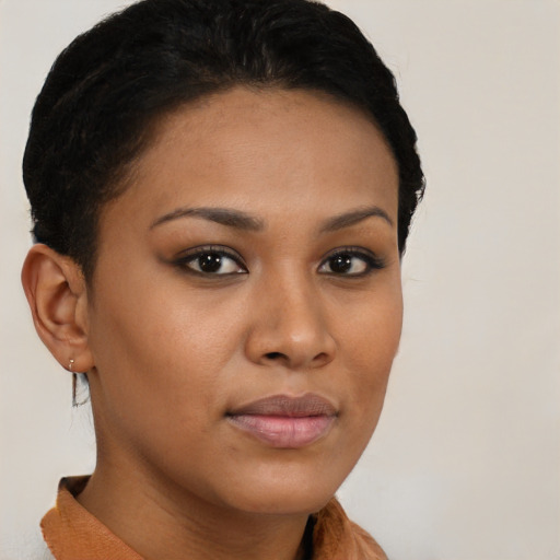 Joyful black young-adult female with short  brown hair and brown eyes