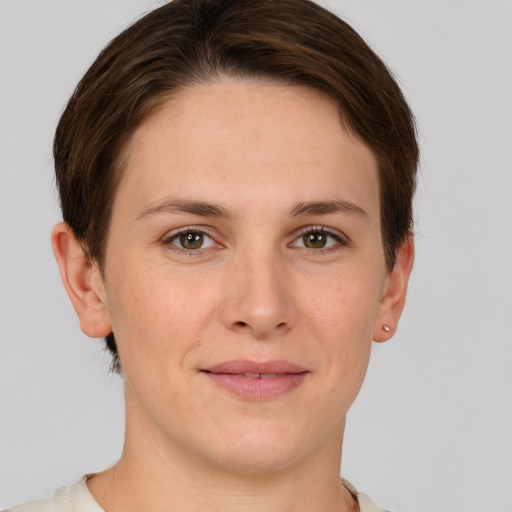 Joyful white young-adult female with short  brown hair and grey eyes