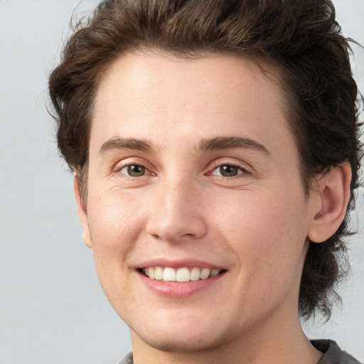 Joyful white young-adult male with medium  brown hair and brown eyes