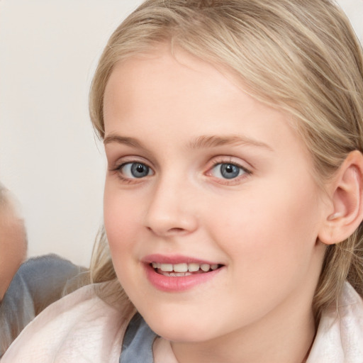 Joyful white child female with medium  brown hair and blue eyes