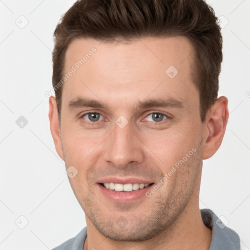 Joyful white young-adult male with short  brown hair and brown eyes