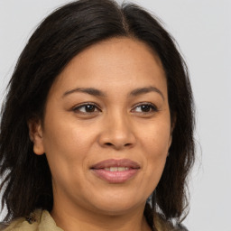 Joyful white adult female with medium  brown hair and brown eyes