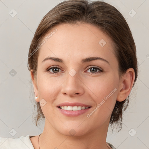 Joyful white young-adult female with medium  brown hair and grey eyes