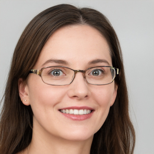 Joyful white young-adult female with long  brown hair and blue eyes