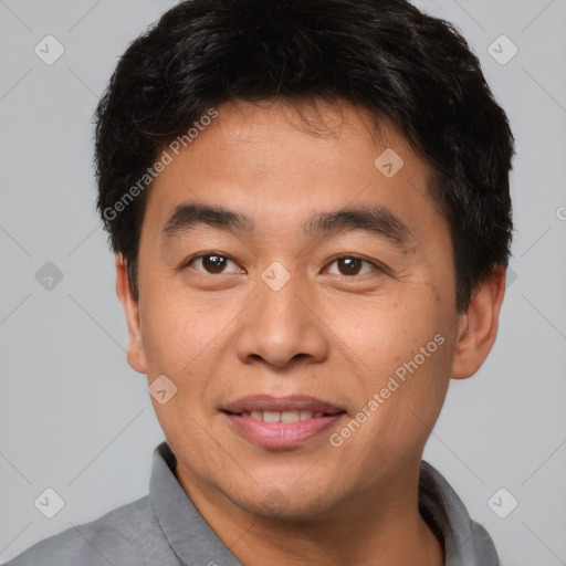 Joyful asian young-adult male with short  brown hair and brown eyes