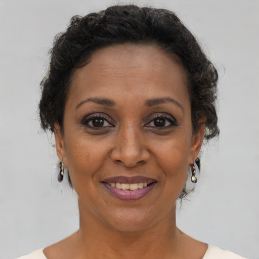 Joyful black adult female with short  brown hair and brown eyes