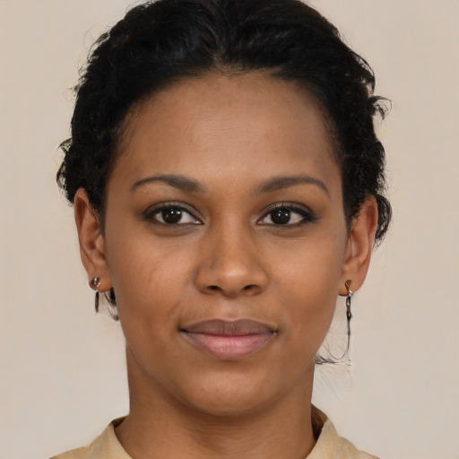 Joyful black young-adult female with short  brown hair and brown eyes