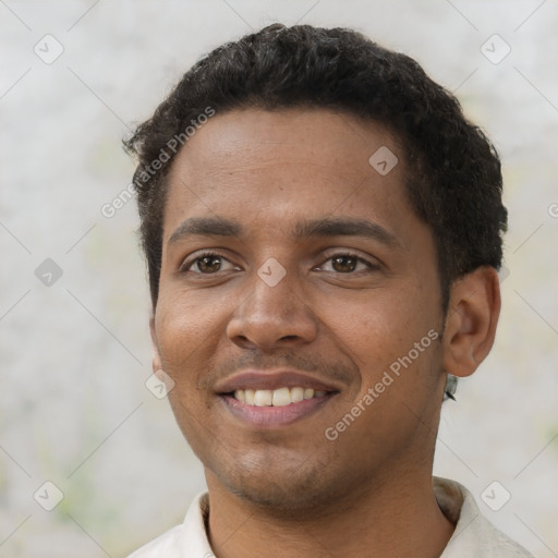 Joyful black young-adult male with short  black hair and brown eyes