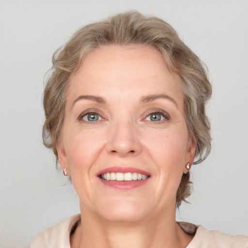 Joyful white adult female with medium  brown hair and blue eyes